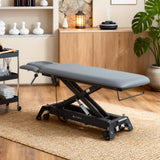 Table de massage électrique fixe grise en environnement professionnel spa - Ambiance intérieure avec rangements